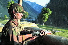 A jawan keeps vigil at the Baltal base camp, 115 km from Srinagar, on Tuesday