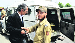 The police takes advocate and human rights activist Parvez Imroz into custody in Srinagar on Tuesday. Tribune Photo: Amin War