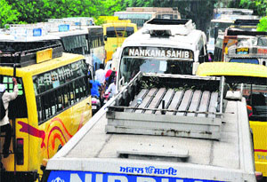 Buses parked outside Guru Dev Nanak Bhawan to ferry poll material and officials on election duty  in Ludhiana on Tuesday. 
