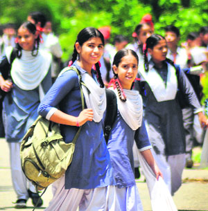 Children after attending classes as the schools re-opened after the summer vacations in Ludhiana on Tuesday.