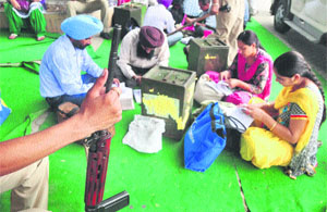 Officials check the election material outside Guru Dev Nanak Bhawan.