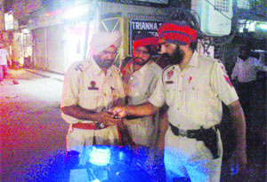 Policemen look at the visuals of a CCTV camera at BRS Nagar, Ludhiana, on Tuesday.