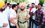 A police officer tries to pacify protesters in Abohar. 