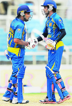 Mahela Jayawardene and Upul Tharanga celebrate in Kingston on Tuesday. 