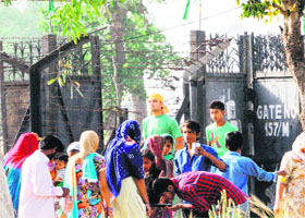 Indian devotees at a gate of the mausoleum of Peer Baba Sheikh Braham at Khemkaran on the Indo-Pak border