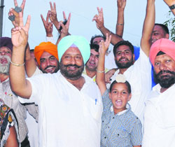 Avtar Singh Gosal (left) and his supporters in a jubilant mood after he was  elected the sarpanch of Dhaun village in Mohali on Wednesday. 