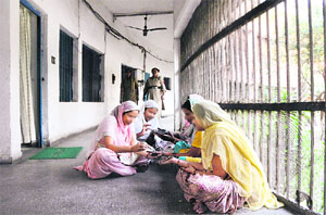 Inmates in a women’s cell at Ludhiana jail applying henna on their palms ahead of the Karvachauth festival. File photo: Himanshu Mahajan