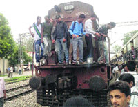 Passengers block the rail track at Kesri village in Ambala district on Wednesday. Photo: Dev Dutt Sharma