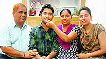 Parents and sister of Vishal Lakha celebrate his success at their home in Nakodar near Jalandhar on Wednesday
