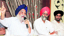 Kultar Singh Jogi, president of Punjab Colonisers and Property Dealers Association, accompanied by his associates, addresses a press conference in Jalandhar on Wednesday