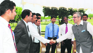 Chief Minister Omar Abdullah shakes hands with a probationary IFS officer during an interactive session in Srinagar on Wednesday. 
