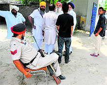 A policeman on election duty outside a polling booth in Hambran village on Wednesday