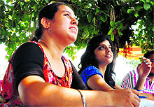 Girls at a helpdesk outside a polling booth at Threeke village on Wednesday