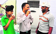 Voters enjoy cold drink in an air-conditioned tent outside a polling booth at Ayali village