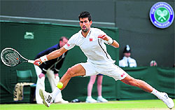 Novak Djokovic returns to Tomas Berdych during their quarterfinal match at the Wimbledon Championships on Wednesday