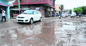 A potholed road along the railway yard near Daria village in Chandigarh.