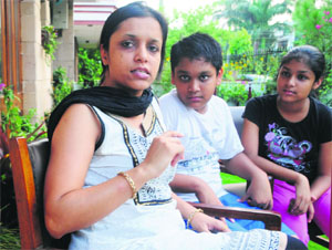 Sonia Goyal, the murdered CA's wife, with her children at their residence in Phase IV, Mohali, on Thursday. 