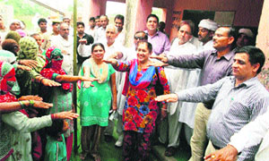 Men and women of Mozam Nagar village take an oath against female foeticide during a night durbar in the village. 