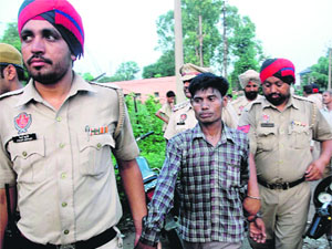Police takes accused Ram Sanjeevan in custody in Jalandhar on Thursday. 