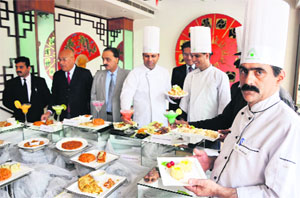 Chefs at Hotel Asia display dishes of 'Tex Mex' American cuisine in Jammu on Thursday.