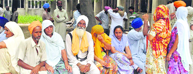 Residents of Chet Singh Wala village wait for the boys body outside the Guru Gobind Singh Medical College, Faridkot, on Thursday.