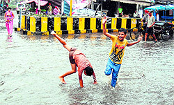 Children play in the rainwater in Amritsar on Friday