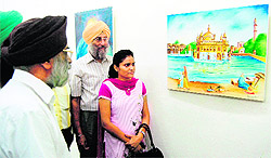Visitors throng the exhibition at the Art Gallery in Amritsar on Friday