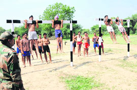 Raising the bar: Candidates do chin-ups during an Army recruitment rally held in Bathinda on Friday. 