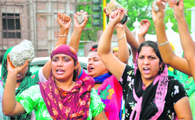 Angry women hold a protest at Mauli Baidwan village in Mohali on Friday.