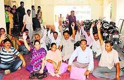 Dehradun Municipal Corporation employees stage a protest on the premises of the corporation in Dehradun on Friday
