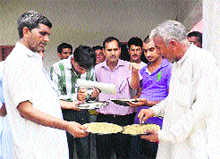 Residents show infected food items to Block Education Officer Shamsher Singh (extreme right) at the school in Kakot village on Friday. 