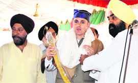 Sikh leaders present a holy sword to Chief Minister Omar Abdullah at Chatti Padshahi Gurdwara in Srinagar on Friday.