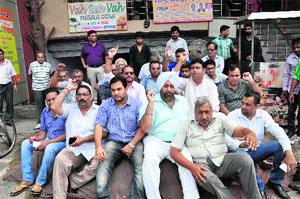 Residents protest against the opening of a liquor vend on Dandi Swami Road in Ludhiana on Friday. 