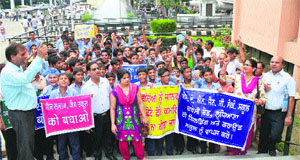 Teachers of SAN Jain Senior Secondary School outside the Mini-Secretariat after submitting a memorandum to the Additional Deputy Commissioner in Ludhiana on Friday. 