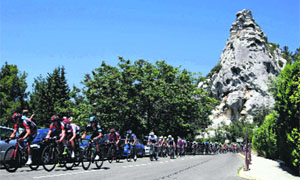 The pack of riders cycles on its way during the centenary Tour de France cycling race from Aix-En-Provence to Montpellier on Friday. 