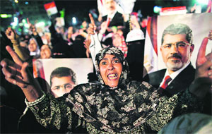 Supporters of Mohamed Mursi raise slogans while holding his portrait at a rally  in Cairo on Thursday. 