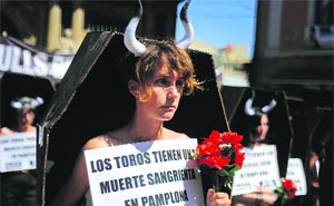 Activists of the People for the Ethical Treatment of Animals and pro-animal groups stand in coffins, which represent the 48 bulls that will be killed during the San Fermin festivities in the Spanish city of Pamplona, during an anti-bullfighting protest on Friday.