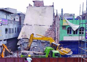 The debris of a four-storey building that collapsed at Jaffrabad in northeast Delhi is being removed on Saturday