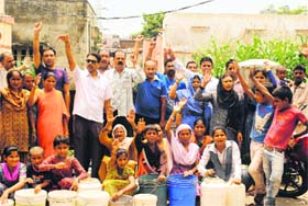 Seeking water: Dehradun city residents stage a protest outside the Jal Nigam office, demanding that the many drinking water pipelines that have been damaged due to the recent rains in the city be repaired so that they can get water in their homes soon