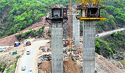 Work continues on the four-laning of Jammu-Srinagar highway at Jajjar Kotli near Jammu on Saturday