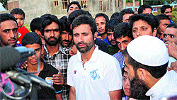 Kashmiri all-rounder Parvez Rasool surrounded by fans as he talks to the media at his house in Bijbehara town of Anantnag district on Saturday