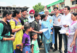 Members of Divisional Rail User Consultative Committee, Ferozepur Division, distribute brochures at the Jammu railway station on Saturday.