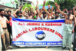 Casual labourers of the Power Development Department protest against non-payment of their salaries in Srinagar on Saturday.