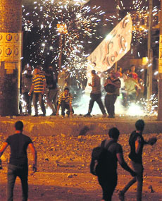Supporters of Mohamed Mursi clash with protesters near Cairos Tahrir Square on Friday. 