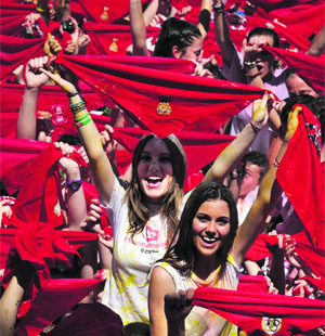 Participants hold red scarves as they celebrate the start of the nine-day San Fermin bull-running festival at Pamplona in Spain on Saturday. 