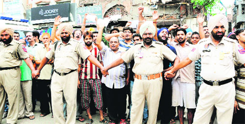 Shopkeepers protest during the visit of BJP chief Rajnath Singh near Jallanwala Bagh in Amritsar on Sunday.