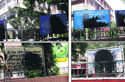 The defaced display boards of various government departments along Madhya Marg, Chandigarh.