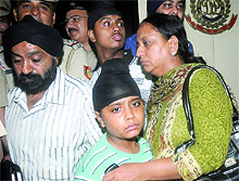 The boy, who was kidnapped, with his parents during a press conference at PHQ in New Delhi on Sunday