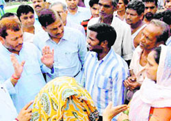 Teerath Singh Rawat, Uttarakhand BJP chief, meets flood victims at Bairagi camp at Haridwar on Sunday. 