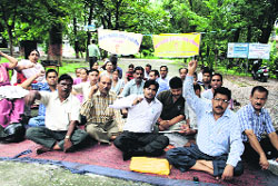 The non-teaching staff of MKP College protests against non-payment of salaries in Dehradun on Sunday.